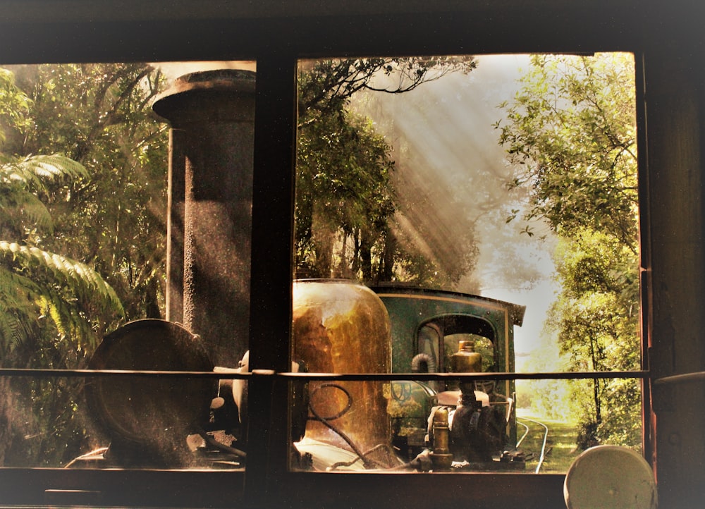 a window view of a train in the woods