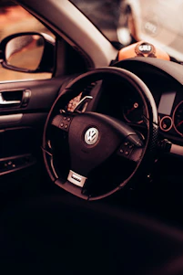 Close-up of custom Volkswagen car mats fitted precisely inside a car interior.