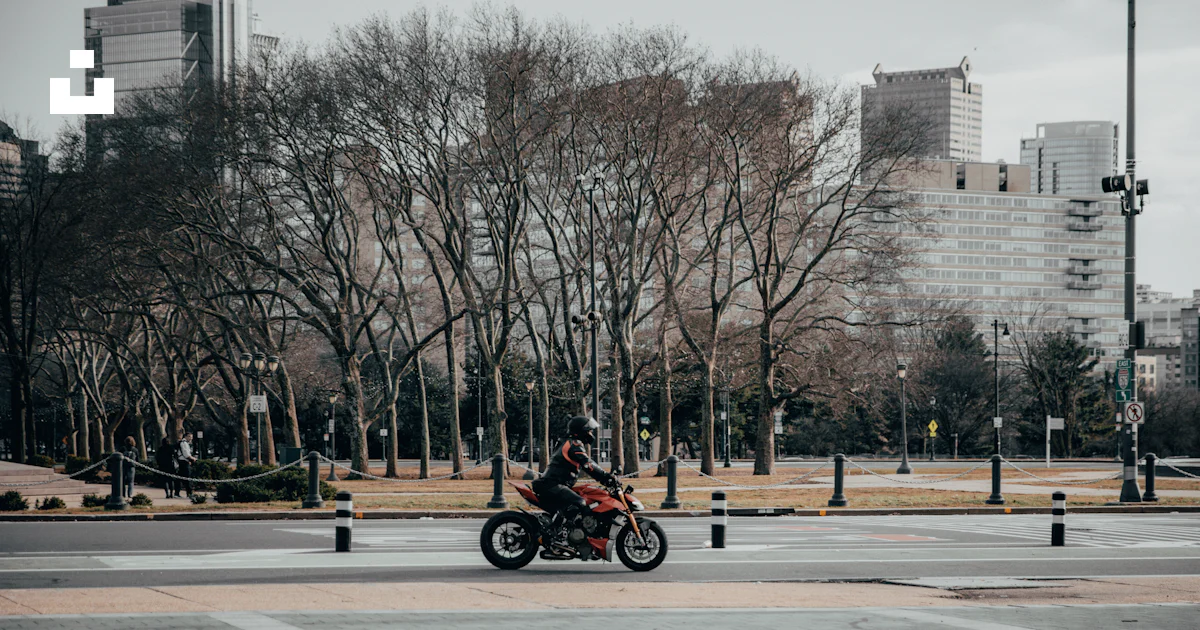 Street Riding Motorcycle A person riding a motorcycle on a city street photo – Free City Image ...