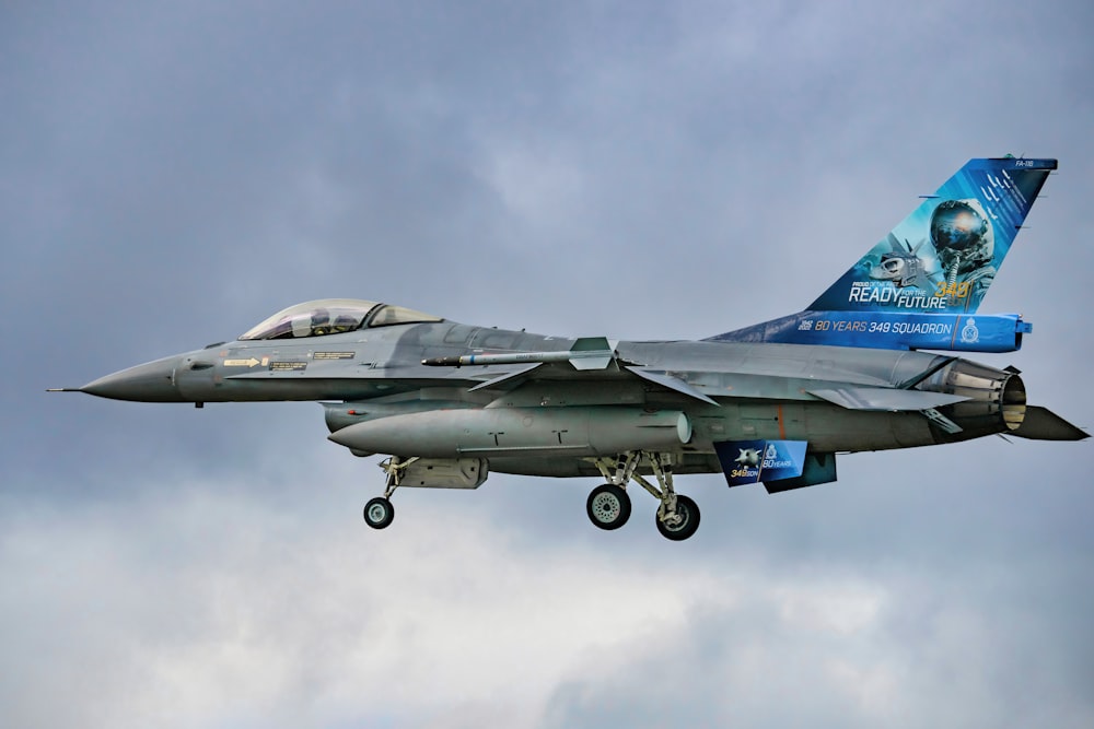 a fighter jet flying through a cloudy sky