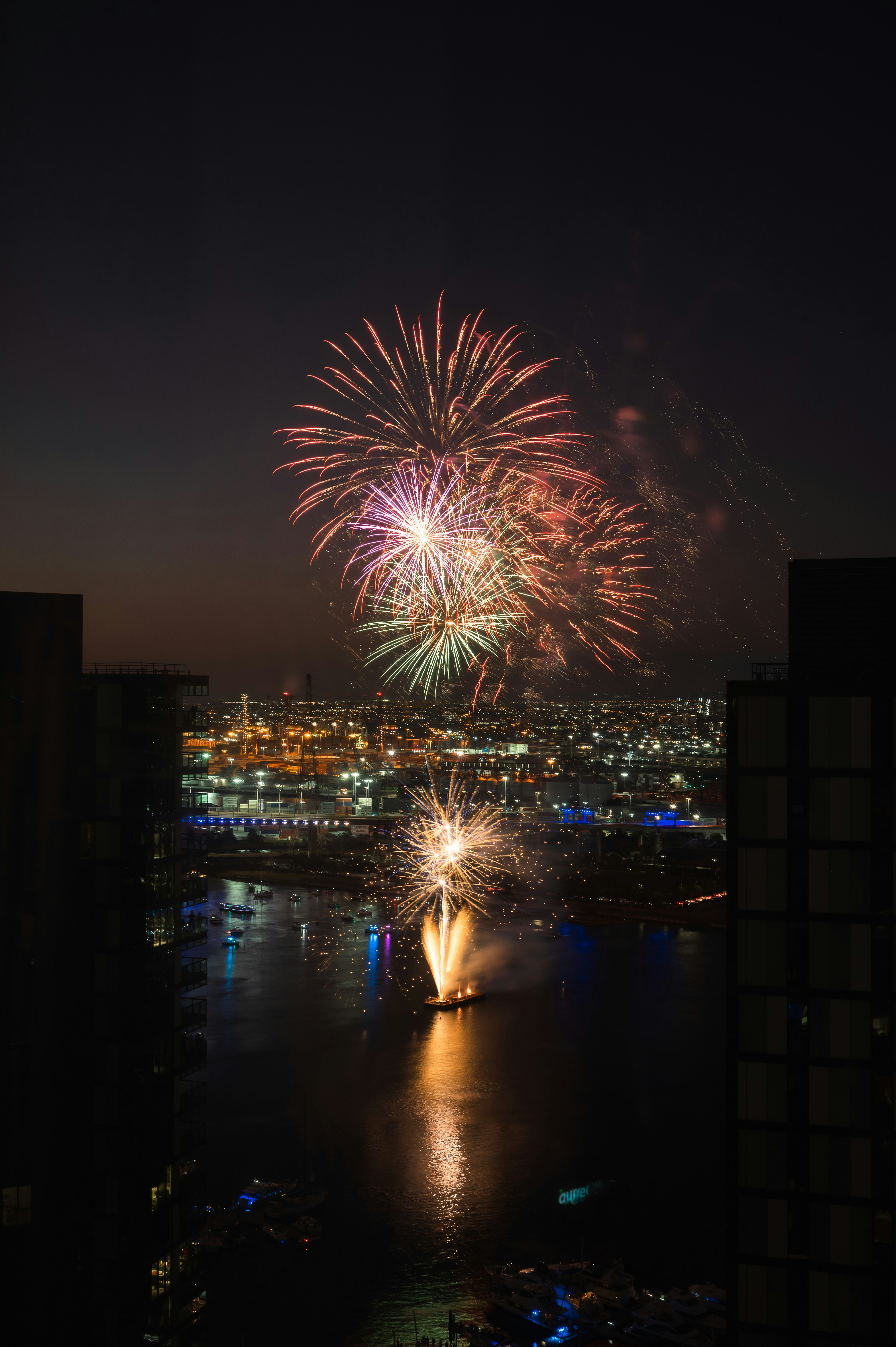 a fireworks display over a city at night