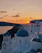 Smiling woman enjoying a sunset view over the Aegean Sea from a luxury Greek villa terrace.