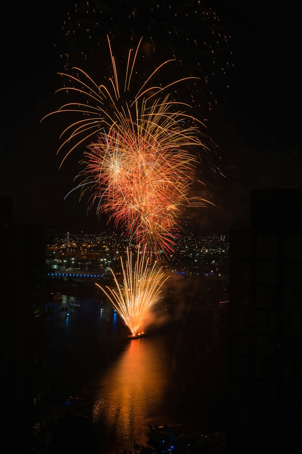 a firework display over a city at night