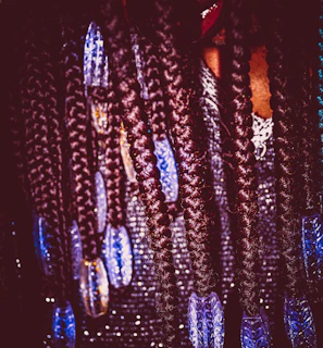 Close-up of intricate cornrows with colorful beads woven in