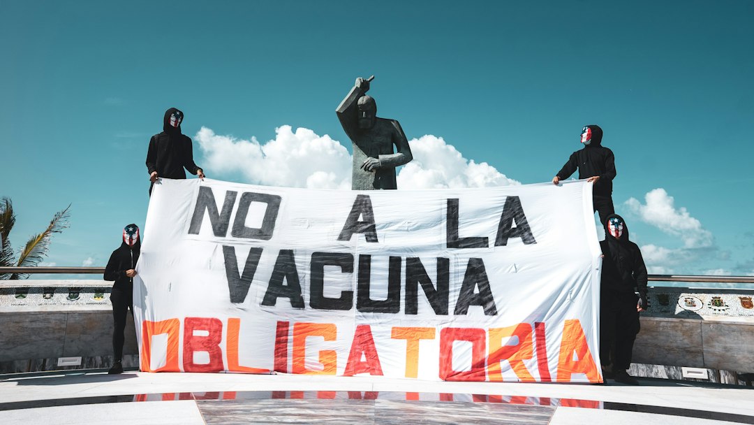a group of people standing next to a large sign