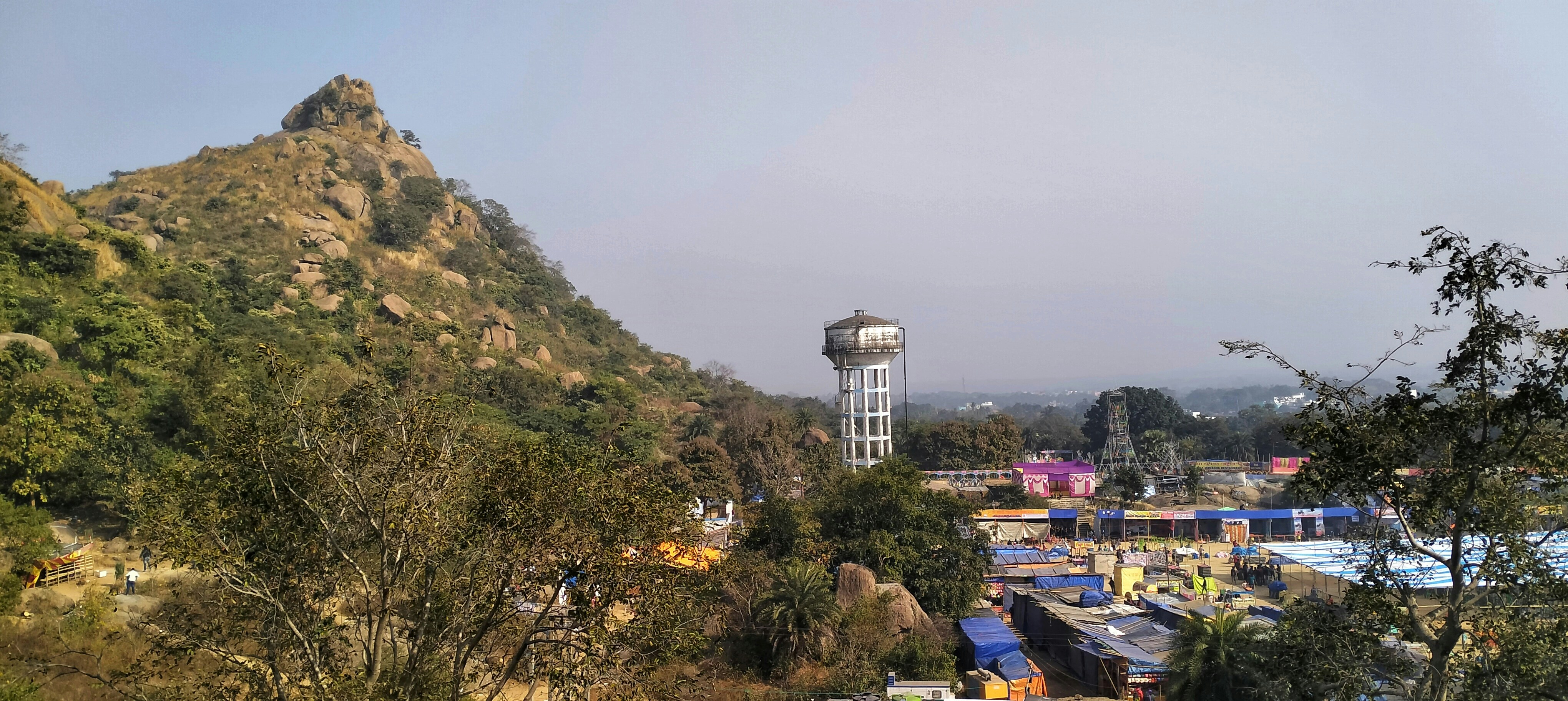 a view of a mountain with a water tower in the distance