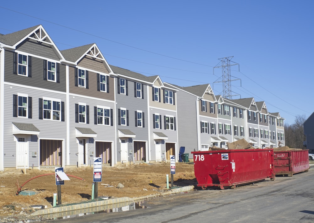 a row of houses with a red truck parked in front of them