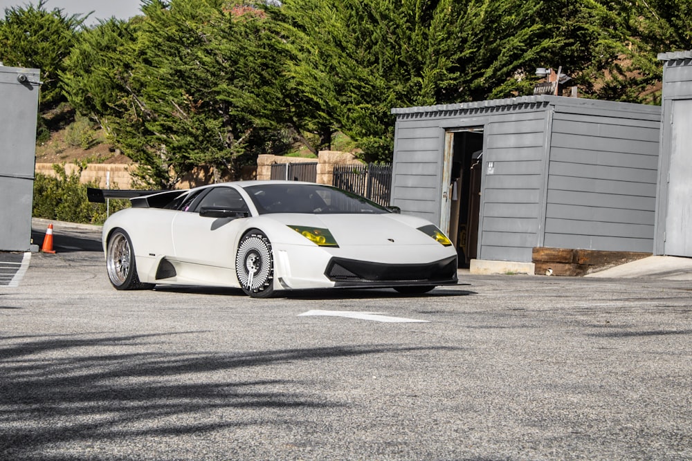 a white sports car parked in a parking lot