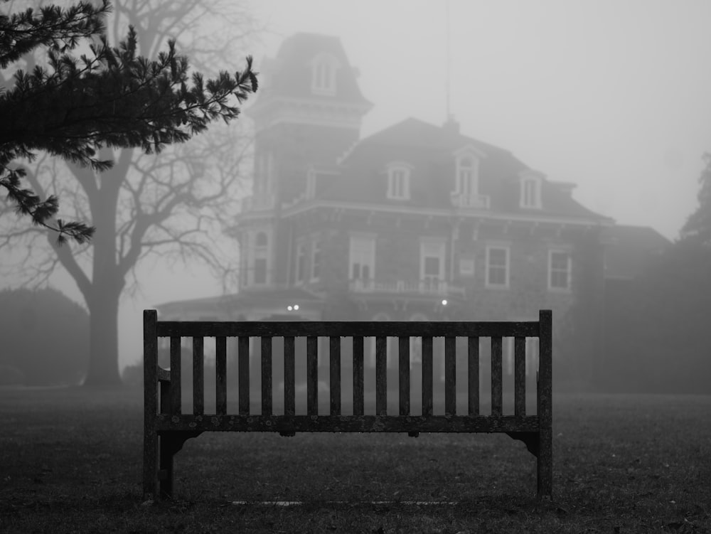 a wooden bench sitting in front of a large building