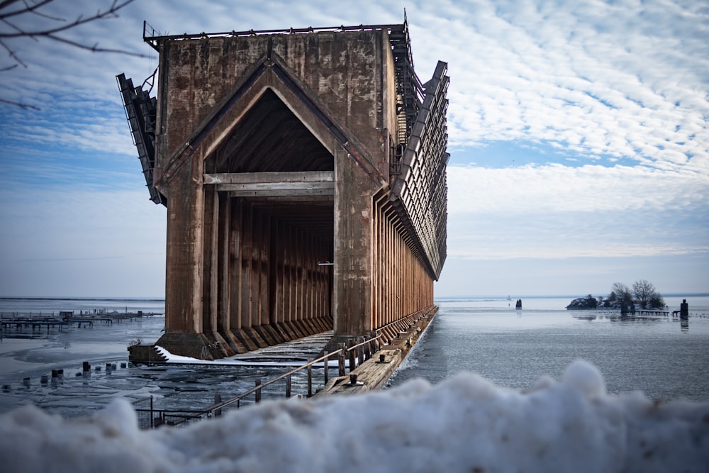 a wooden structure sitting on top of snow covered ground