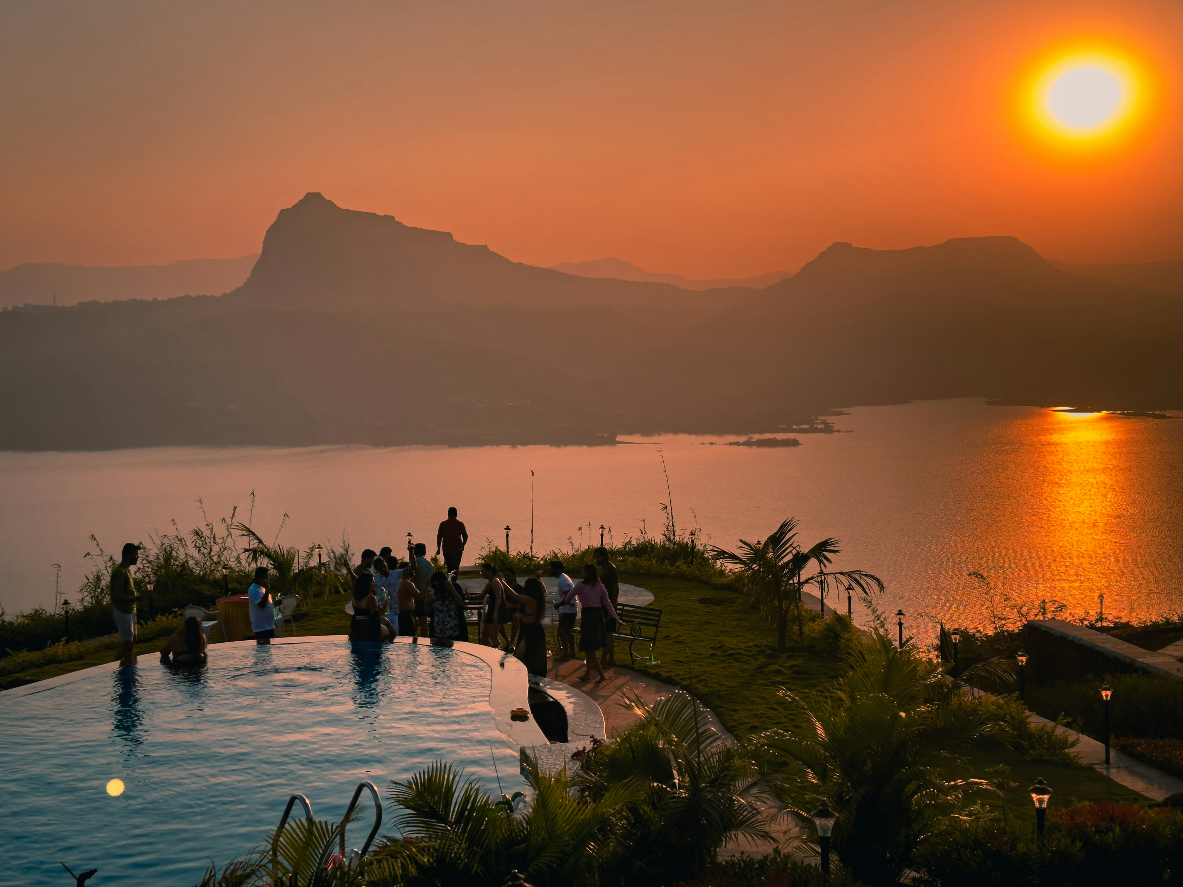A group of people standing around a swimming pool photo – Free Pavna ...
