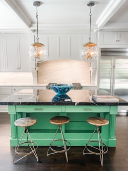 A stunning marble hunter green kitchen island with sleek countertops in a luxury Texas home.