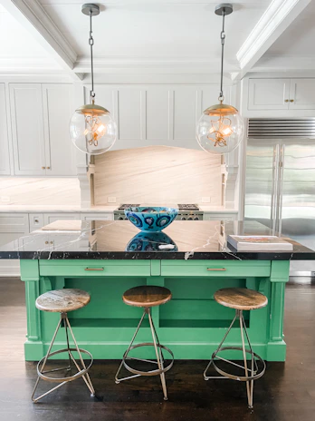 Close-up of a remodeled kitchen island with fresh paint and updated fixtures.