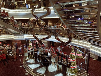 a group of people standing around a christmas tree