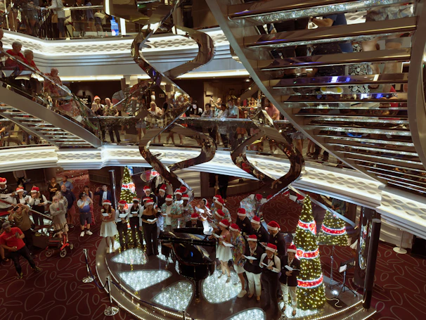 a group of people standing around a christmas tree
