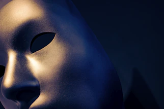 Close-up of a sleek medical LED mask glowing softly on a white background.