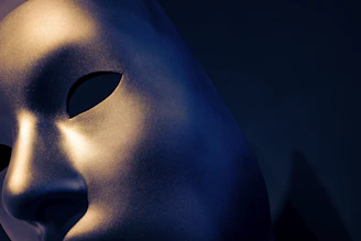 A close-up of a sleek black mask with gold accents resting on a dark velvet surface, illuminated by soft cinematic lighting.