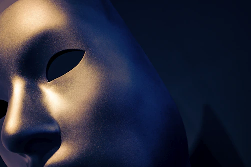 Close-up of a sleek medical LED mask glowing softly on a white background.