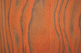 Close-up of creamy shea butter texture on a natural wooden surface.