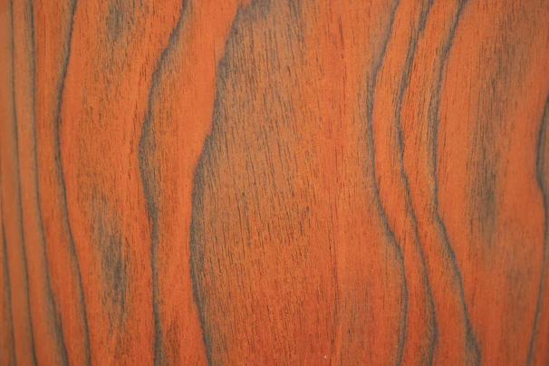 Close-up of a rich brown Indonesian teak cutting board showcasing its smooth grain and natural finish.
