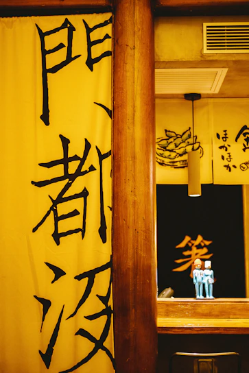 A warm gathering of Japanese and Australian community members sharing stories in a bright, blue-themed room.