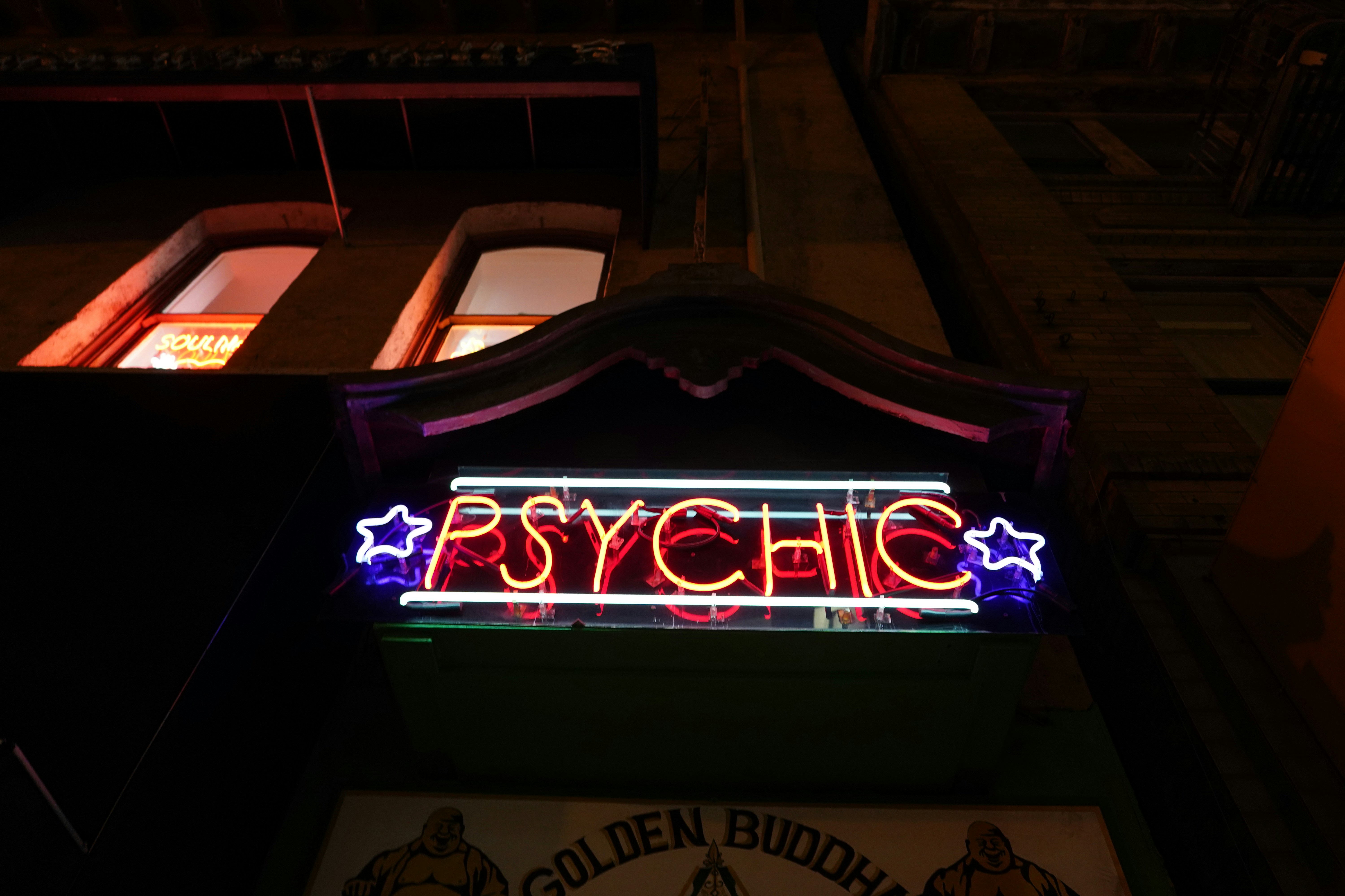 a neon sign on the side of a building, 