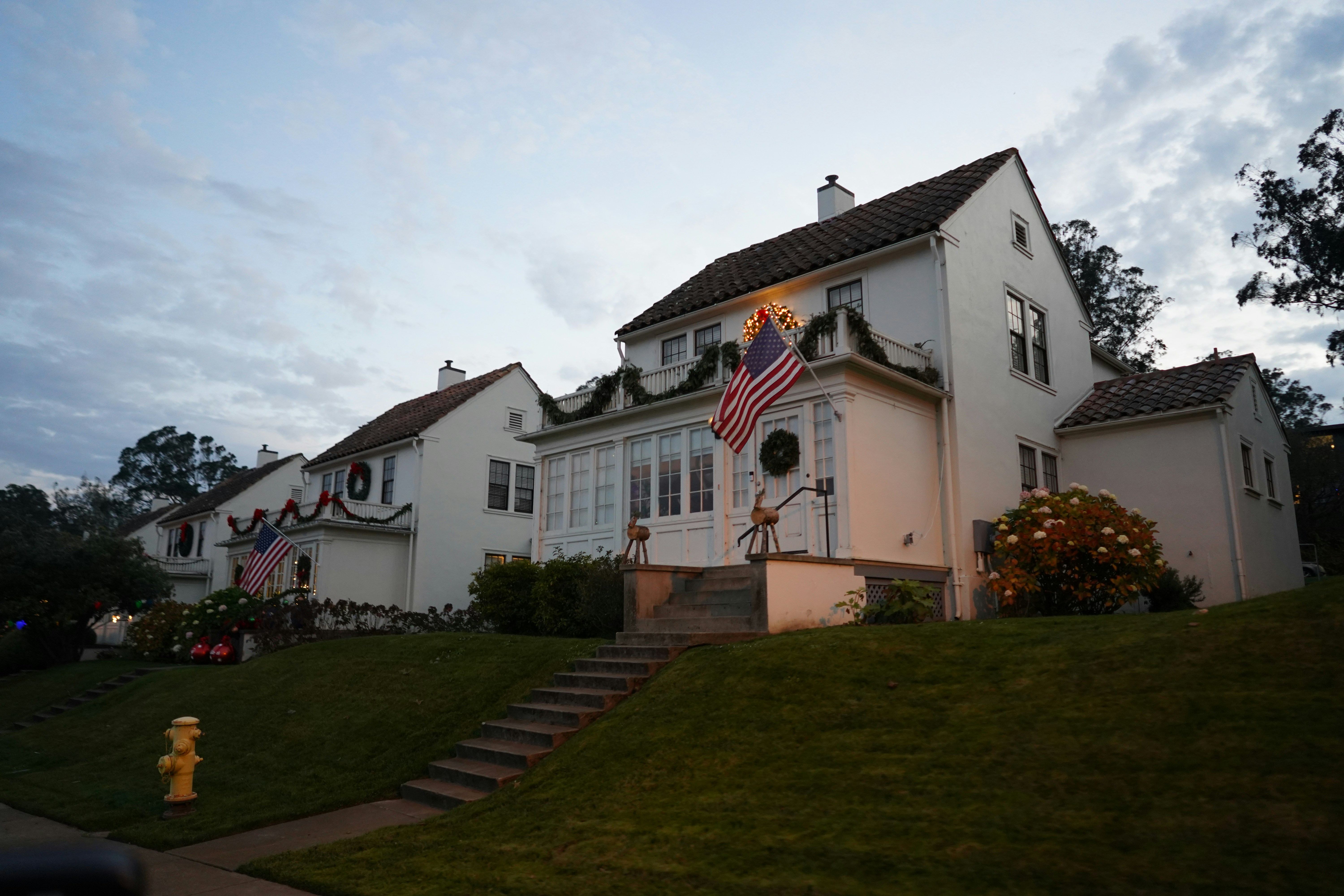 a large white house with a flag on the front of it
