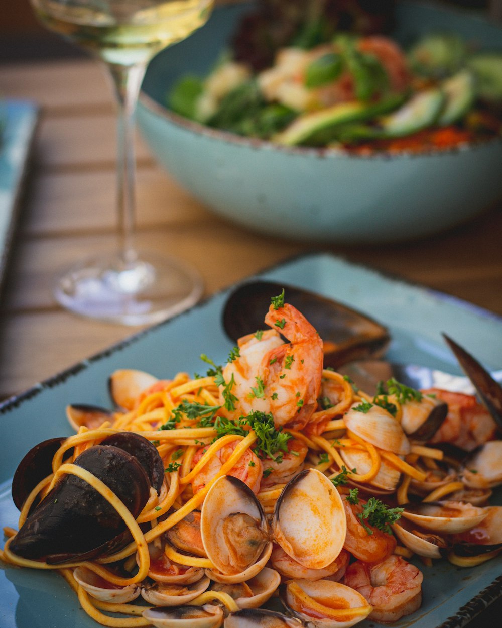 a plate of pasta with shrimp and clams