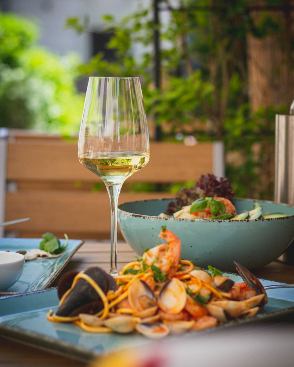 a plate of food and a glass of wine on a table