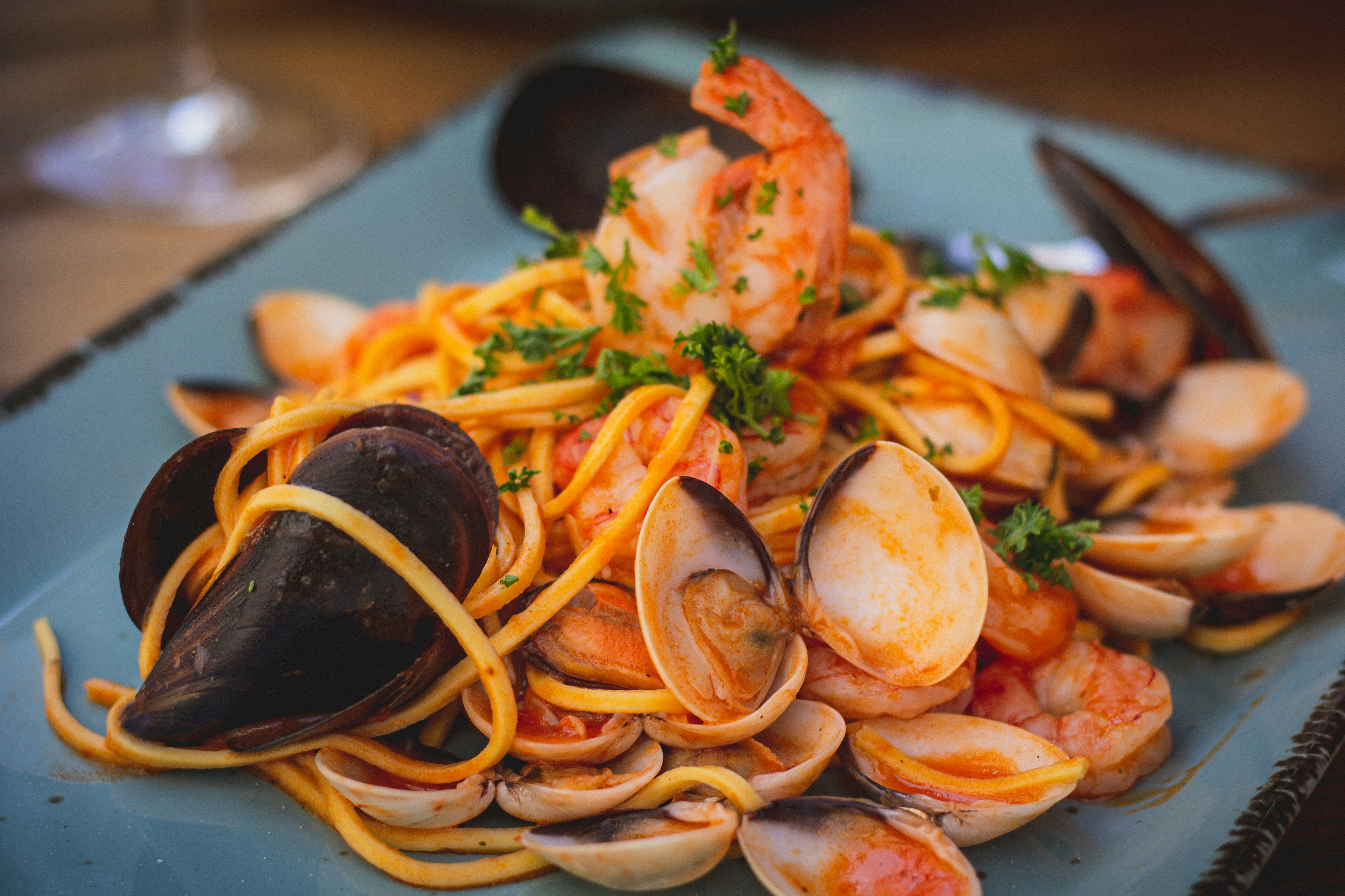 a plate of pasta with clams and shrimp