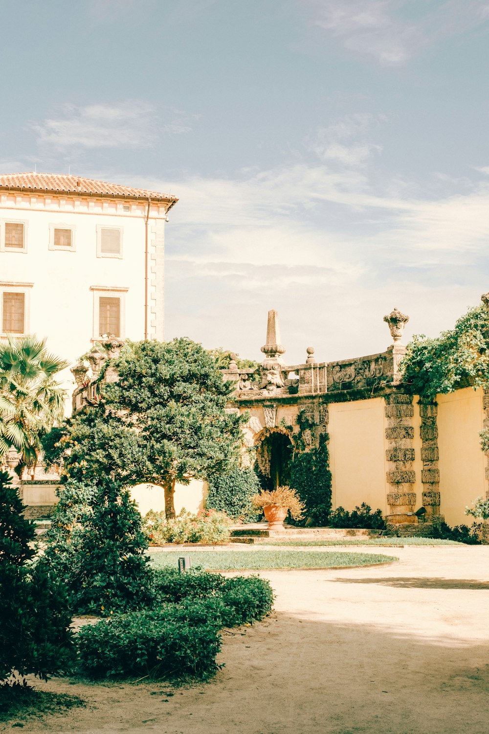 a building with a courtyard and a fountain in front of it