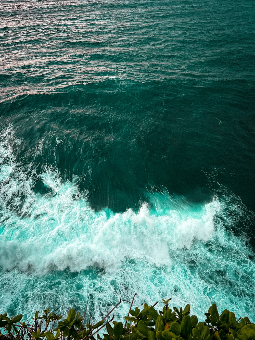 a large body of water with a wave coming in