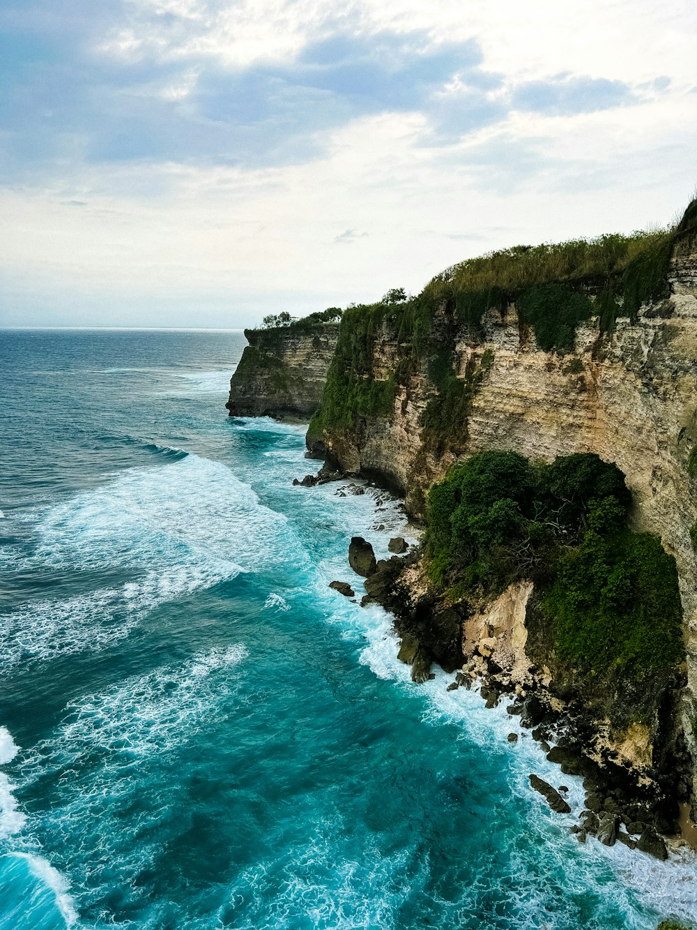 a view of the ocean from the top of a cliff