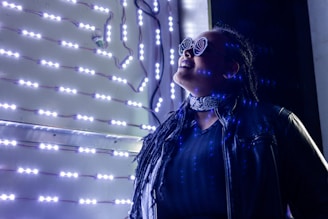 a woman in a black jacket and some lights