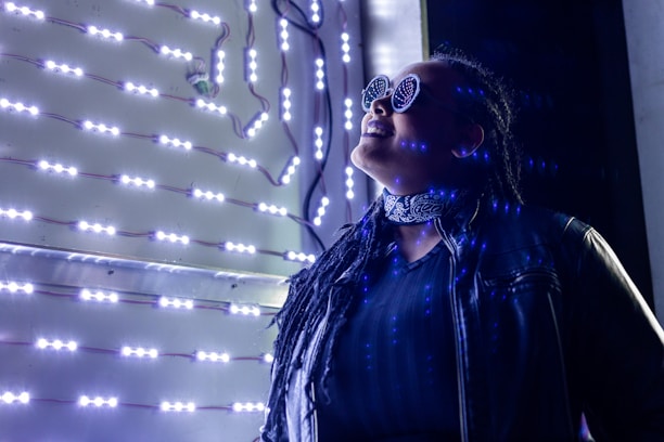 a woman in a black jacket and some lights