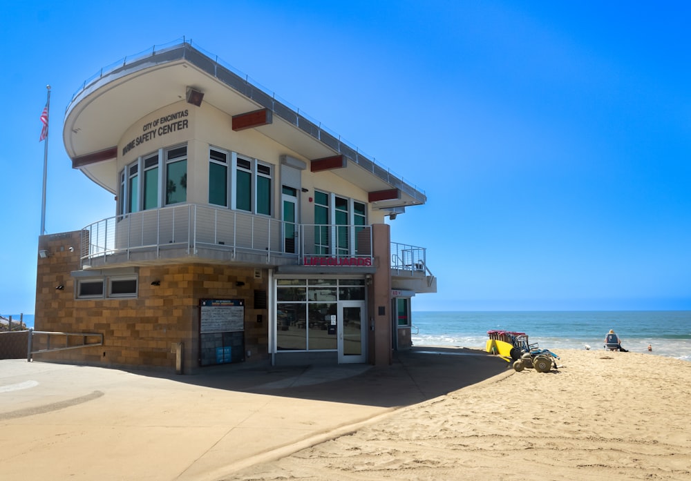 a building on the beach with a surfboard on the beach