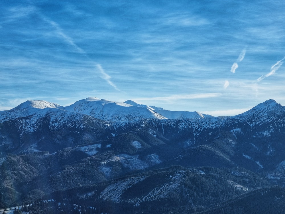 a view of a mountain range with snow on it