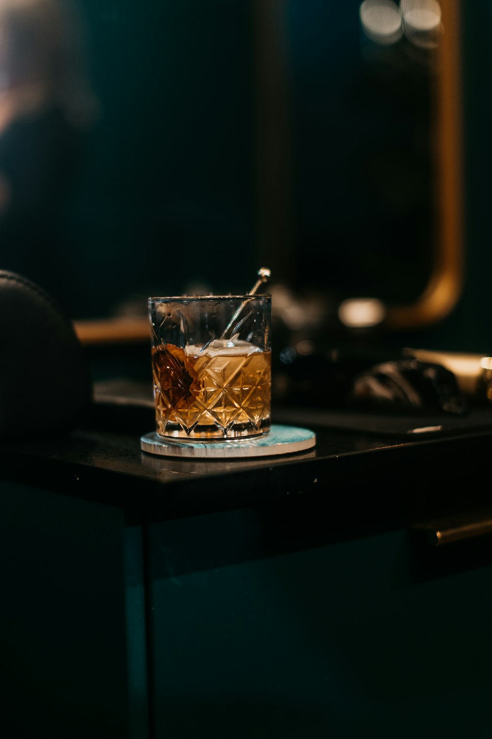 a glass of whiskey sitting on top of a counter