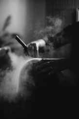 a black and white photo of a person smoking a cigarette