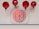 Red Chinese lanterns are suspended above a shelf with a circular white plaque displaying a traditional red Chinese symbol.