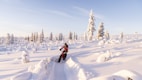a person riding a snow bike on a snowy surface