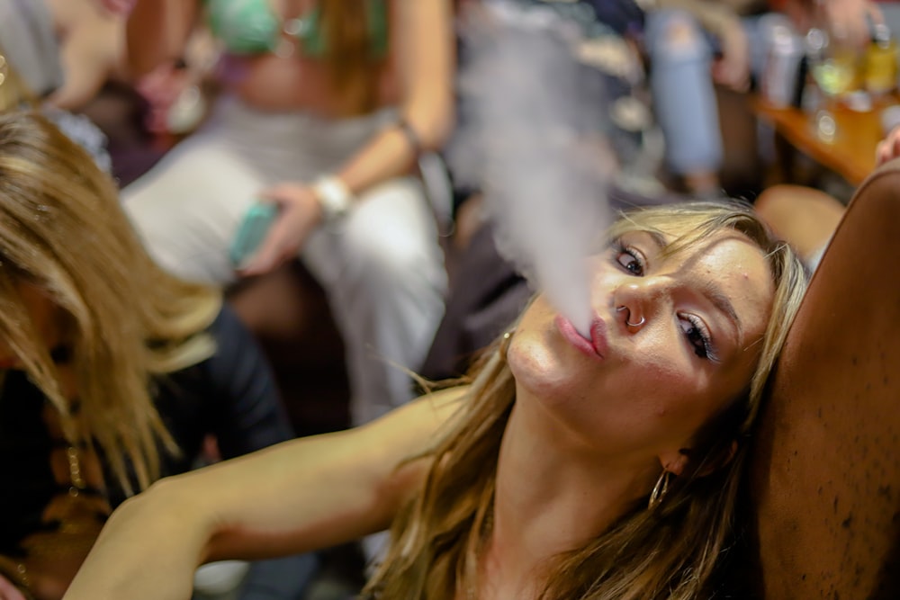 a woman smoking a cigarette in a bar