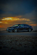 A sleek 2023 Volvo S90 parked curbside in East Hampton at sunset, ready for a city ride.