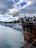 A group of young sailors laughing and preparing their boat on a sunny Croatian marina.