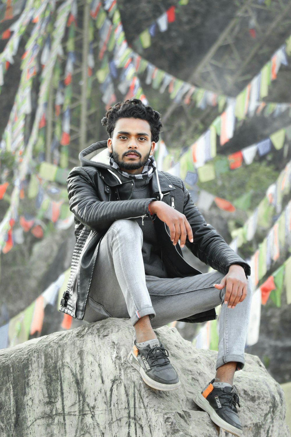 a man sitting on top of a rock