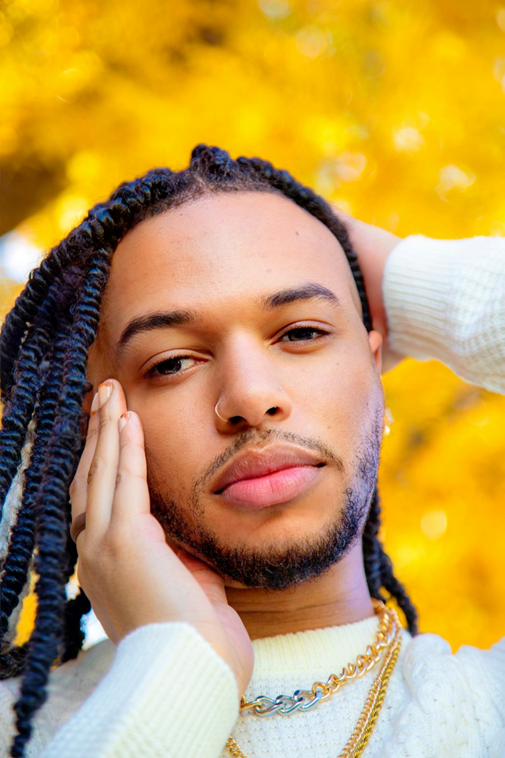 a man with dreadlocks is posing for a picture