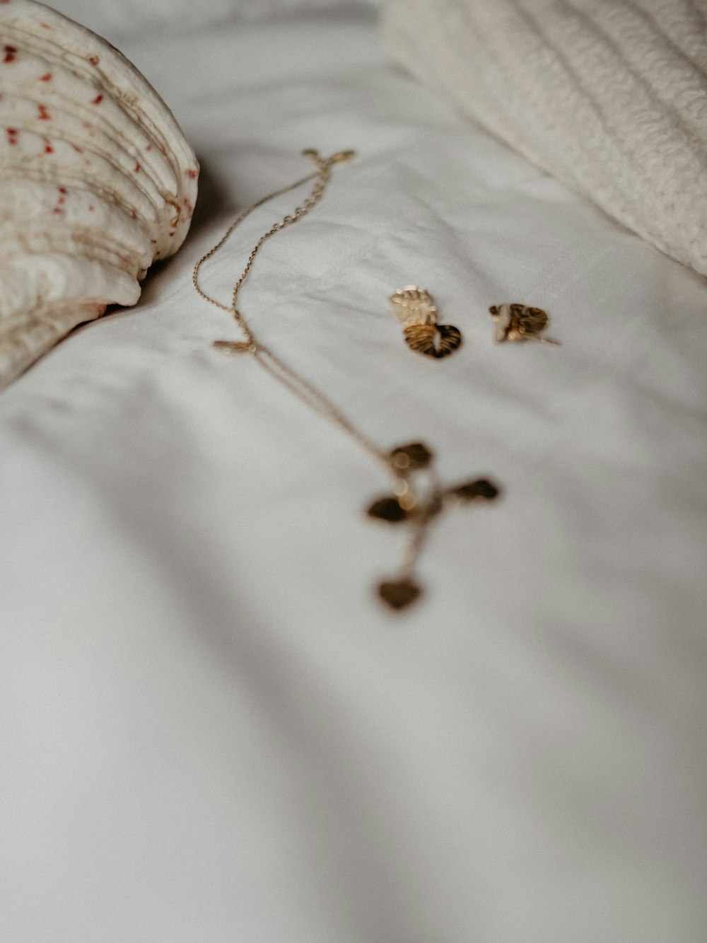 a seashell is laying on a white bed