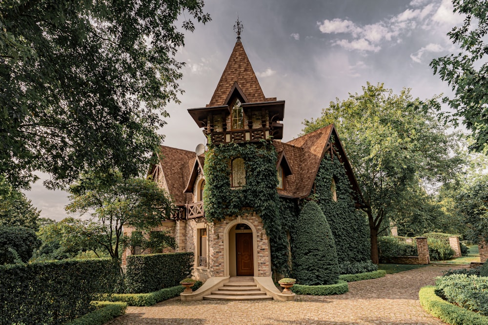 a house covered in ivy and surrounded by trees