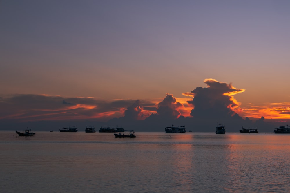 a group of boats floating on top of a large body of water