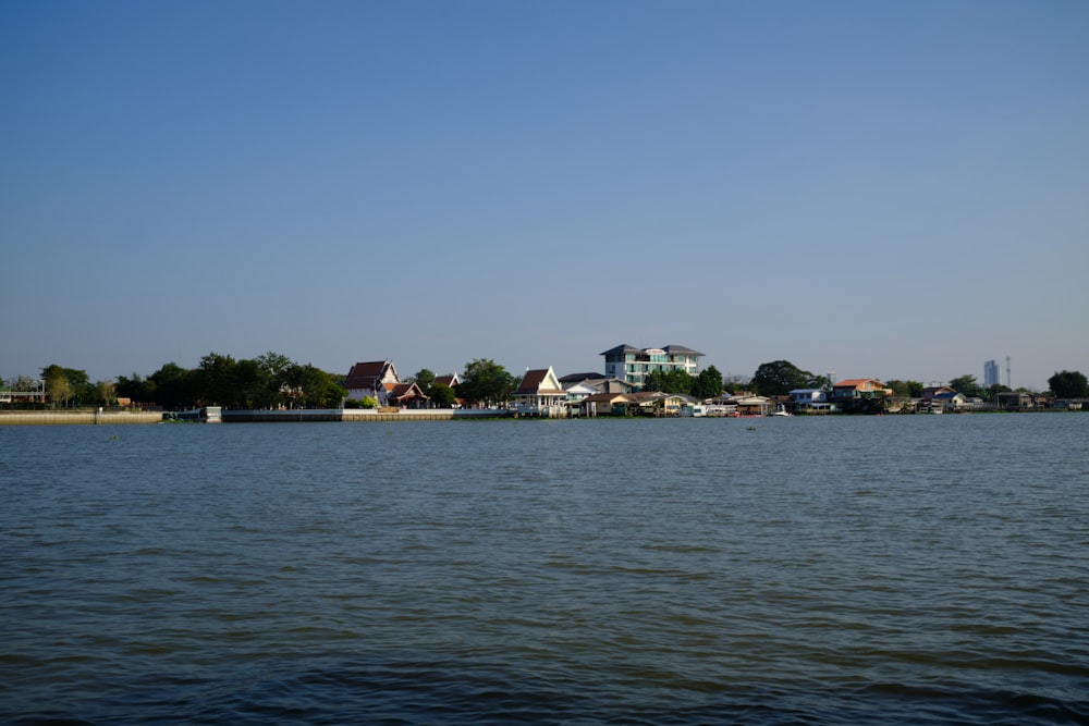 a body of water with houses in the background